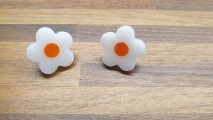 White daisy studs with orange centres