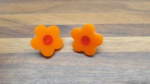 orange daisy studs with live red centres