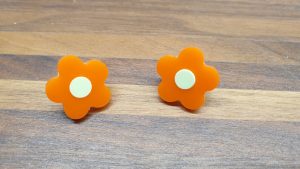 orange daisy studs with yellow centres