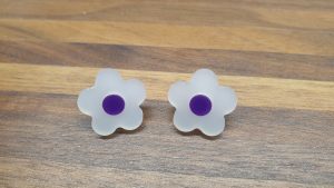 frosted white daisy studs with purple centres